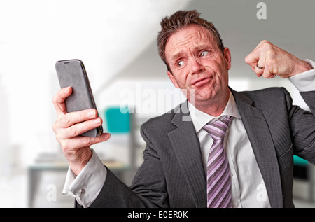 A frustrated businessman on a telephone call. Stock Photo