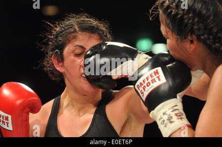 Ulm, Germany. 10th May, 2014. Rola El-Halabi (L), professional German boxer of Lebanese origine, in action against Victoria Cisneros of the USA during their WBF title fight in Ulm, Germany, 10 May 2014. WBF Light welterweight Champion Rola El Halabi successfully defended her title. Photo: STEFAN PUCHNER/dpa/Alamy Live News Stock Photo