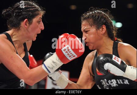 Ulm, Germany. 10th May, 2014. Rola El-Halabi (L), professional German boxer of Lebanese origine, in action against Victoria Cisneros of the USA during their WBF title fight in Ulm, Germany, 10 May 2014. WBF Light welterweight Champion Rola El Halabi successfully defended her title. Photo: STEFAN PUCHNER/dpa/Alamy Live News Stock Photo