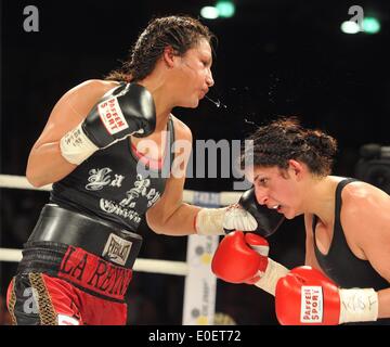 Ulm, Germany. 10th May, 2014. Rola El-Halabi (R), professional German boxer of Lebanese origine, in action against Victoria Cisneros of the USA during their WBF title fight in Ulm, Germany, 10 May 2014. WBF Light welterweight Champion Rola El Halabi successfully defended her title. Photo: STEFAN PUCHNER/dpa/Alamy Live News Stock Photo