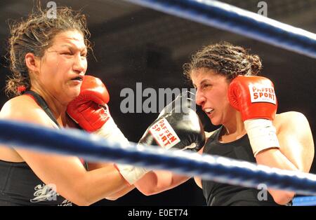 Ulm, Germany. 10th May, 2014. Rola El-Halabi (R), professional German boxer of Lebanese origine, in action against Victoria Cisneros of the USA during their WBF title fight in Ulm, Germany, 10 May 2014. WBF Light welterweight Champion Rola El Halabi successfully defended her title. Photo: STEFAN PUCHNER/dpa/Alamy Live News Stock Photo