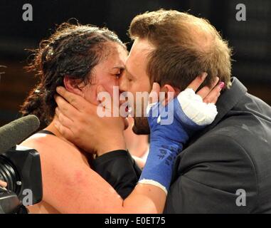 Ulm, Germany. 10th May, 2014. Rola El-Halabi, professional German boxer of Lebanese origine, kisses her husband Konstantin Papastergiou after the WBF title fight against Victoria Cisneros of the USA in Ulm, Germany, 10 May 2014. WBF Light welterweight Champion Rola El Halabi successfully defended her title. Photo: STEFAN PUCHNER/dpa/Alamy Live News Stock Photo