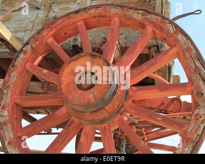 Old wagon wheel on vintage wagon. Stock Photo