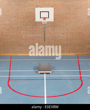 Interior of a gym at school, jumping high at the basket Stock Photo