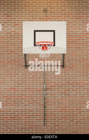 Interior of a gym at school, jumping high at the basket Stock Photo