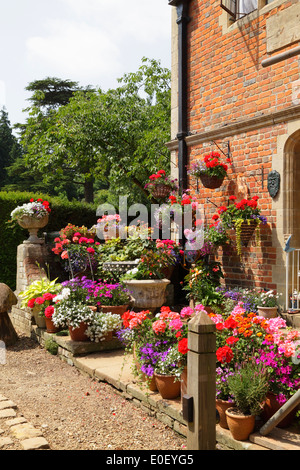 Colourful Floral Display seen through the gateway to Chilham Castle Kent UK Stock Photo