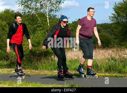 Active people use leisure time on roller skating cycle trail Stock Photo