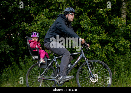 Father with child cycling, toddler bike helmet, bicycle seat Czech Republic, Europe Stock Photo
