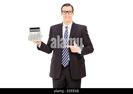 Businessman pointing towards a calculator in his hand Stock Photo