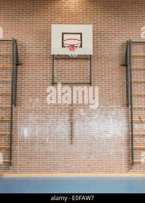 Interior of a gym at school, jumping high at the basket Stock Photo