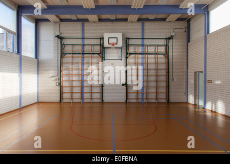 Interior of a gym at school, jumping high at the basket Stock Photo