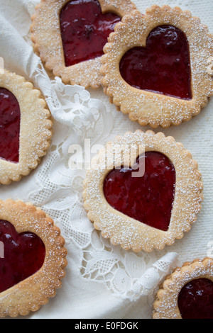 Strawberry Jam, heart shaped Linzer Biscuits on Lace Stock Photo