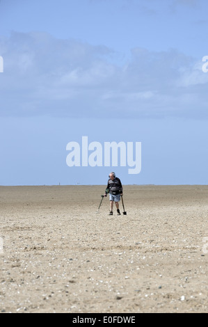 Man using metal detector on Lytham St Annes beach Stock Photo