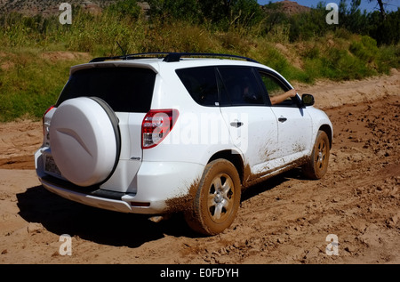 Toyota RAV4 SUV contemplates deep mud at a flooded of road river crossing in the Palo Duro cayon park, Texas, USA Stock Photo