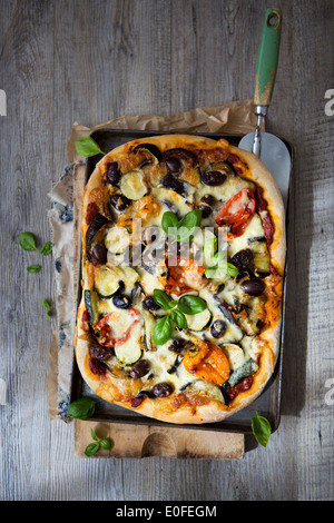 Homemade Roasted Vegetable Pizza with Olives, Basil and Peppers Stock Photo