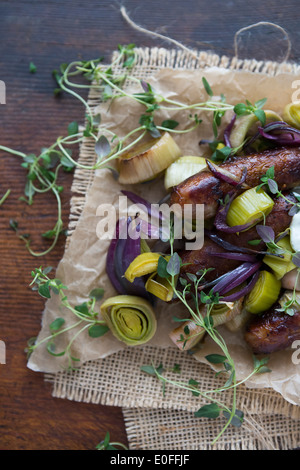 Sausage, Leek, Red Onion & Thyme on Parchment Paper Stock Photo