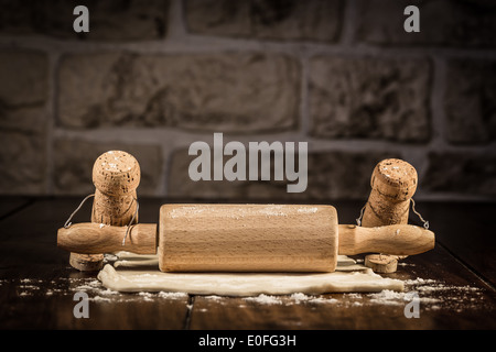 Concept baker to roll some pastry, wine cork figures Stock Photo