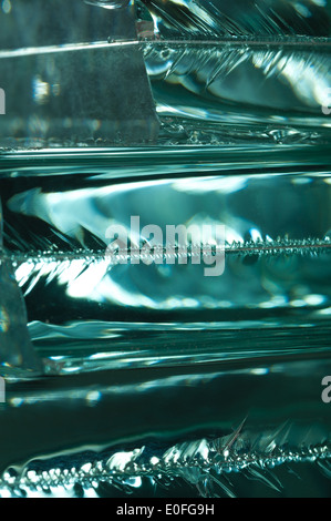 Sharp dangerous edge of plate glass internal reflection brings out green color and depth Stock Photo