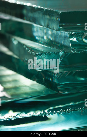 Sharp dangerous edge of plate glass internal reflection brings out green color and depth Stock Photo