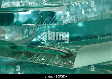 Sharp dangerous edge of plate glass internal reflection brings out green color and depth Stock Photo