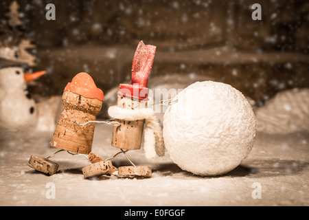 Concept snowball rolling, wine cork figures Stock Photo