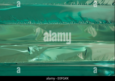 Sharp dangerous edge of plate glass internal reflection brings out green color and depth Stock Photo