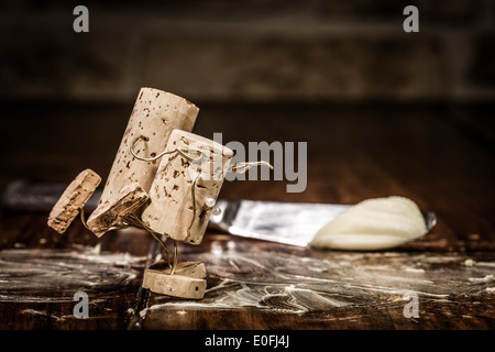 Concept couple is skating on buttered table, wine cork figures Stock Photo