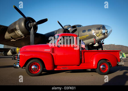 A 1949 Chevrolet pick up next to a Flying Fortress, a B17 from 1945, painted in the same guise as the famous B17 by the name Memphis Belle, in April 2014. Stock Photo