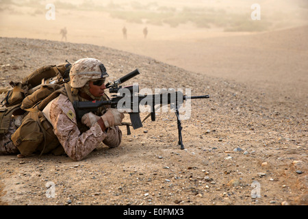 US Marine Lance Cpl. Javier Nunez III a rifleman with the Bravo Company assault force provides security after being inserted by CH-53E Super Stallion helicopters during a counter insurgency mission May 1, 2014 in Tagvreshk Village, Helmand province, Afghanistan. Stock Photo