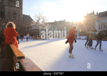 The Christmas ice rink in the Market Square in Bruges, West Flanders, Belgium, Europe Stock Photo