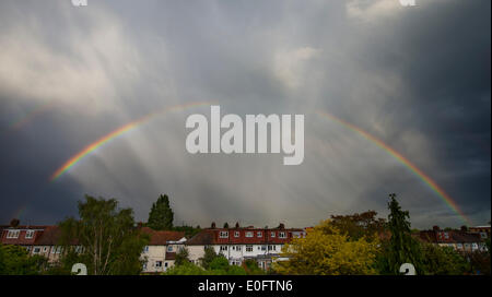 Wimbledon, London, UK. 12th May, 2014. Heavy rain then sunlight this evening creates a double rainbow over rooftops in SW London Credit:  Malcolm Park editorial/Alamy Live News Stock Photo