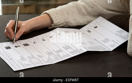 Teenage first time voter with her postal ballot paper for European Parliament election May 2014 with 15 parties to choose from Stock Photo