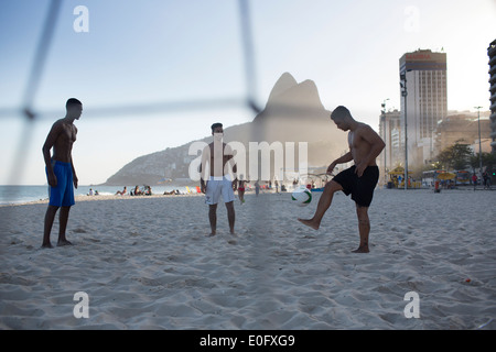 Brazil men playing football on Ipanema and Leblon beach, Rio de Janeiro Stock Photo
