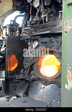 Footplate and firebox of steamed up preserved steam engine 34046 Braunton at Banbury railway station Oxfordshire England UK Stock Photo