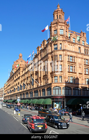 Brompton Road and Harrods luxury department store listed building in Knightsbridge on a blue sky day in West London street England UK Stock Photo