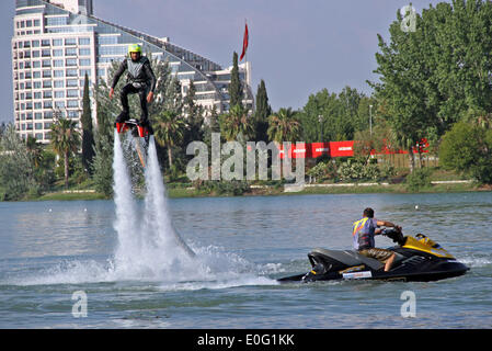 Istanbul. 12th May, 2014. A stunt performer performs with water-propelled flyboard in Adana of Turkey on May 12, 2014. The engine with the applied water pressure can rise 7 meters high to the air. Performers fixed on the flyboard controlled the magnitude and direction of the water pressure to jump and fly above the water. Credit:  Cihan/Xinhua/Alamy Live News Stock Photo