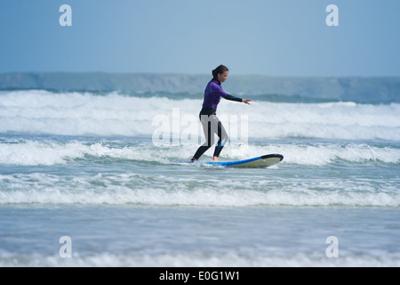 A young female surfer in Newquay, Cornwall, England. Stock Photo