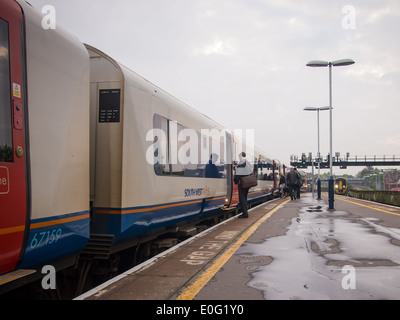 A train at a platform at Portsmouth Harbour Station on a rainy day Stock Photo