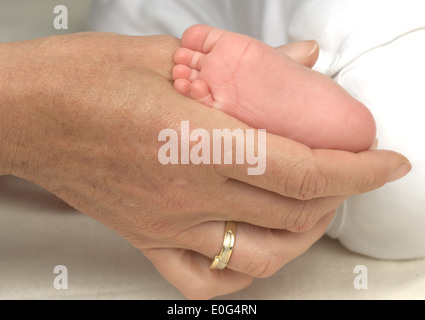 Women's hand and baby foot , Frauenhand und Babyfuss Stock Photo