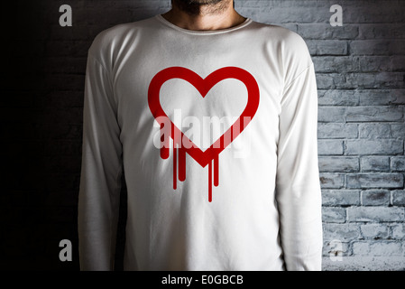 Hearbleed bug symbol on white shirt. Male hacker in dark room. Stock Photo