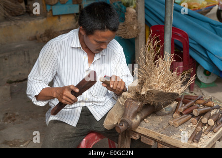 Artist Carving Face in Tree Root in Old Town Workshop Hoi An Vietnam Stock Photo