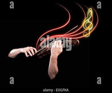 Hands playing wooden violin with notes flying on black background Stock Photo