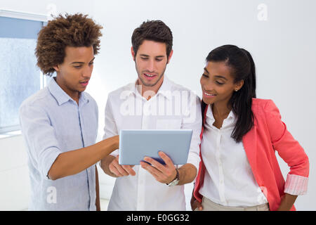 Three colleagues working on tablet pc Stock Photo