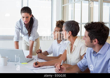 Business people using laptops and notebooks in meeting Stock Photo