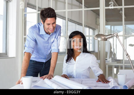Architects working hard on blueprints Stock Photo