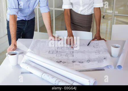Two architects looking at blueprints Stock Photo