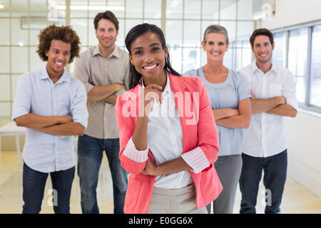 Well dressed workers with arms folded smiling at camera Stock Photo