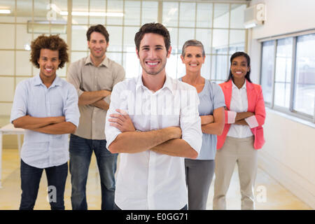 Workers with arms folded and smiling at camera Stock Photo