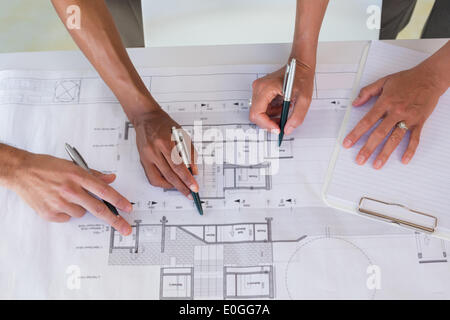 Team of architects going over blueprints Stock Photo