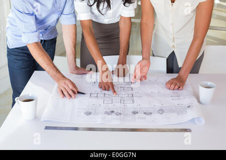 Group of architects working on blueprints Stock Photo